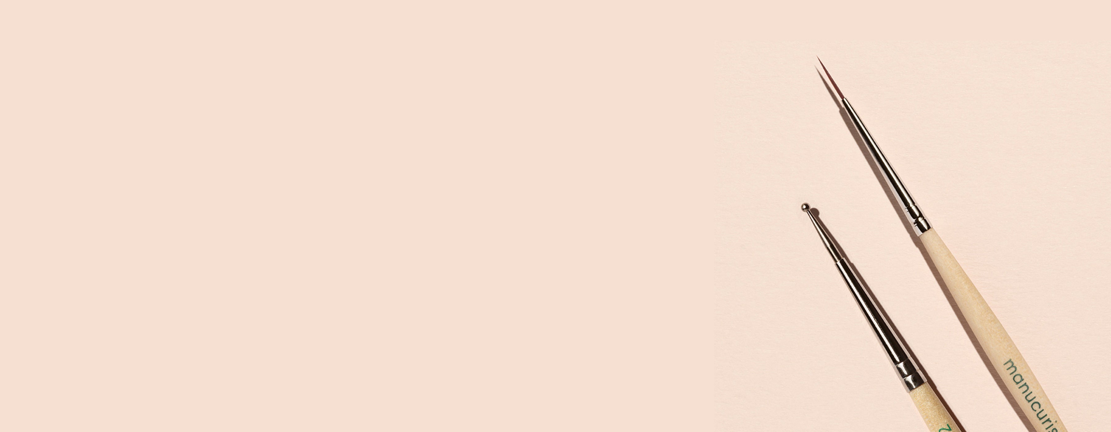 Two nail art brushes with light wooden handles and fine metal tips placed on a beige background, positioned vertically on the right side with empty space on the left.