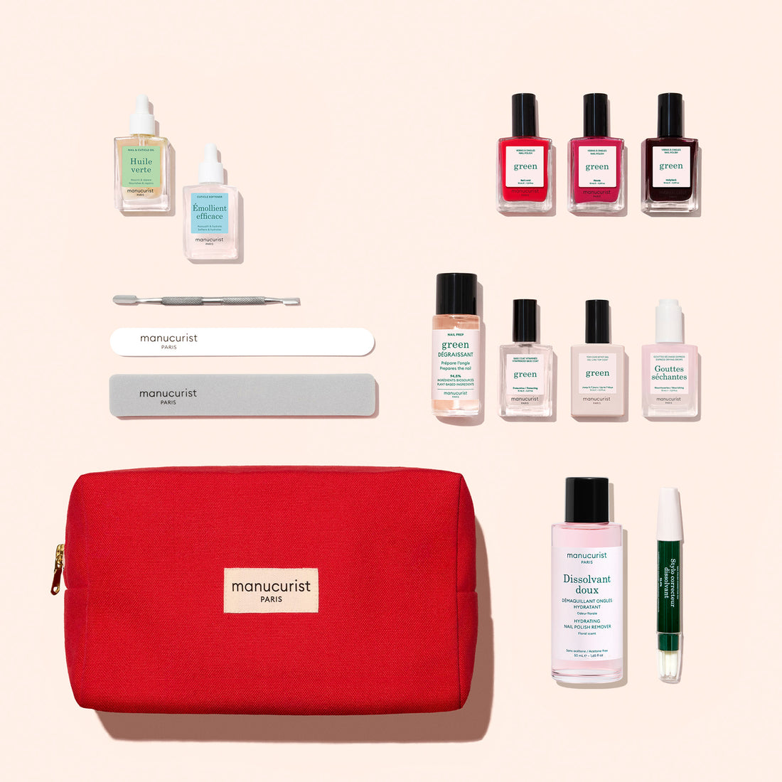 The Ultimate Kit by Manucurist features a red manicure pouch filled with nail care tools, files, a cuticle pusher, gel-effect nail polishes in assorted colors, a green pen, and small bottles of vitaminized base coat along with other nail treatment products, all neatly arranged beside the pouch.