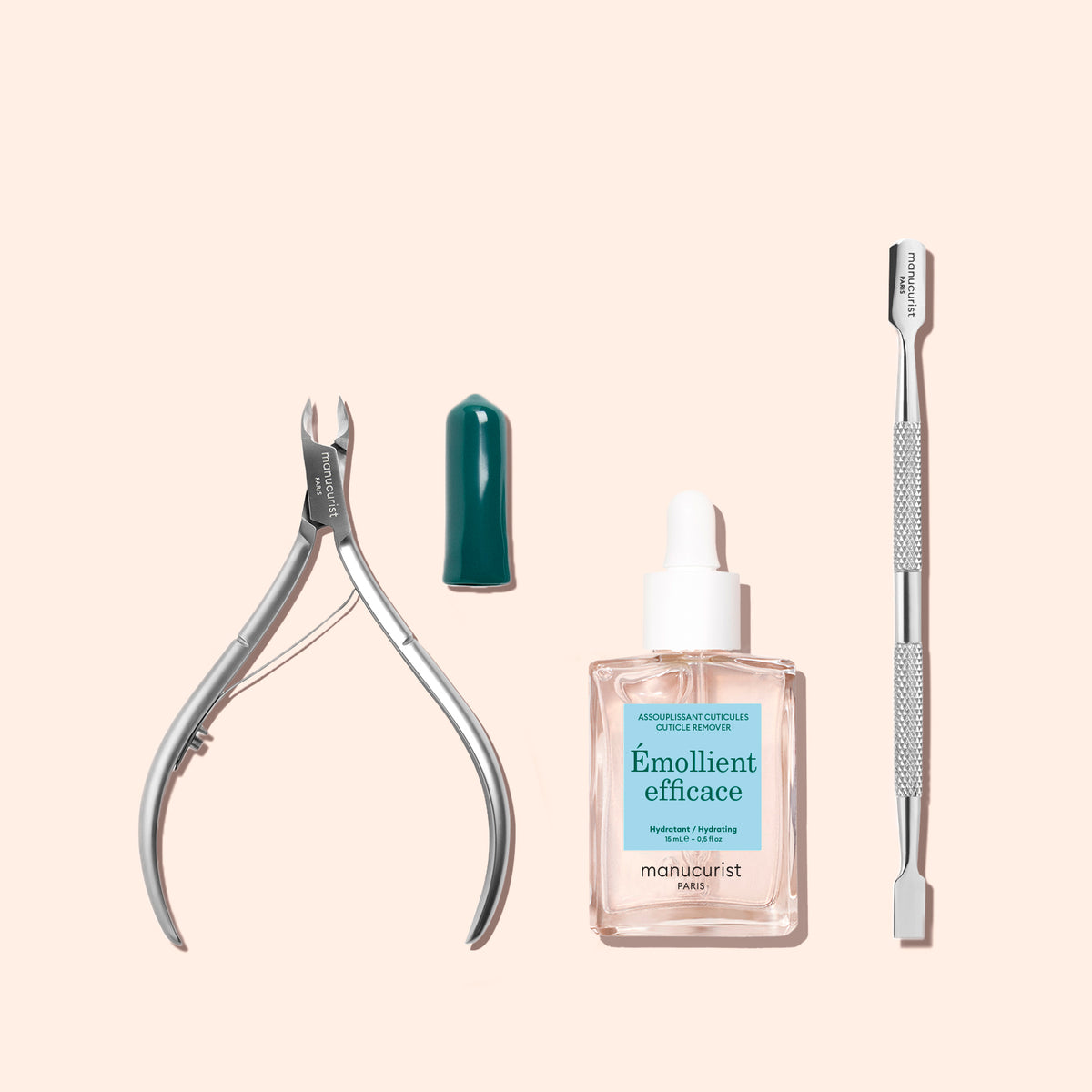 Manucurist Cuticle Clippers with a small dark green cap, a bottle of cuticle remover, and a dual-ended metal cuticle pusher.