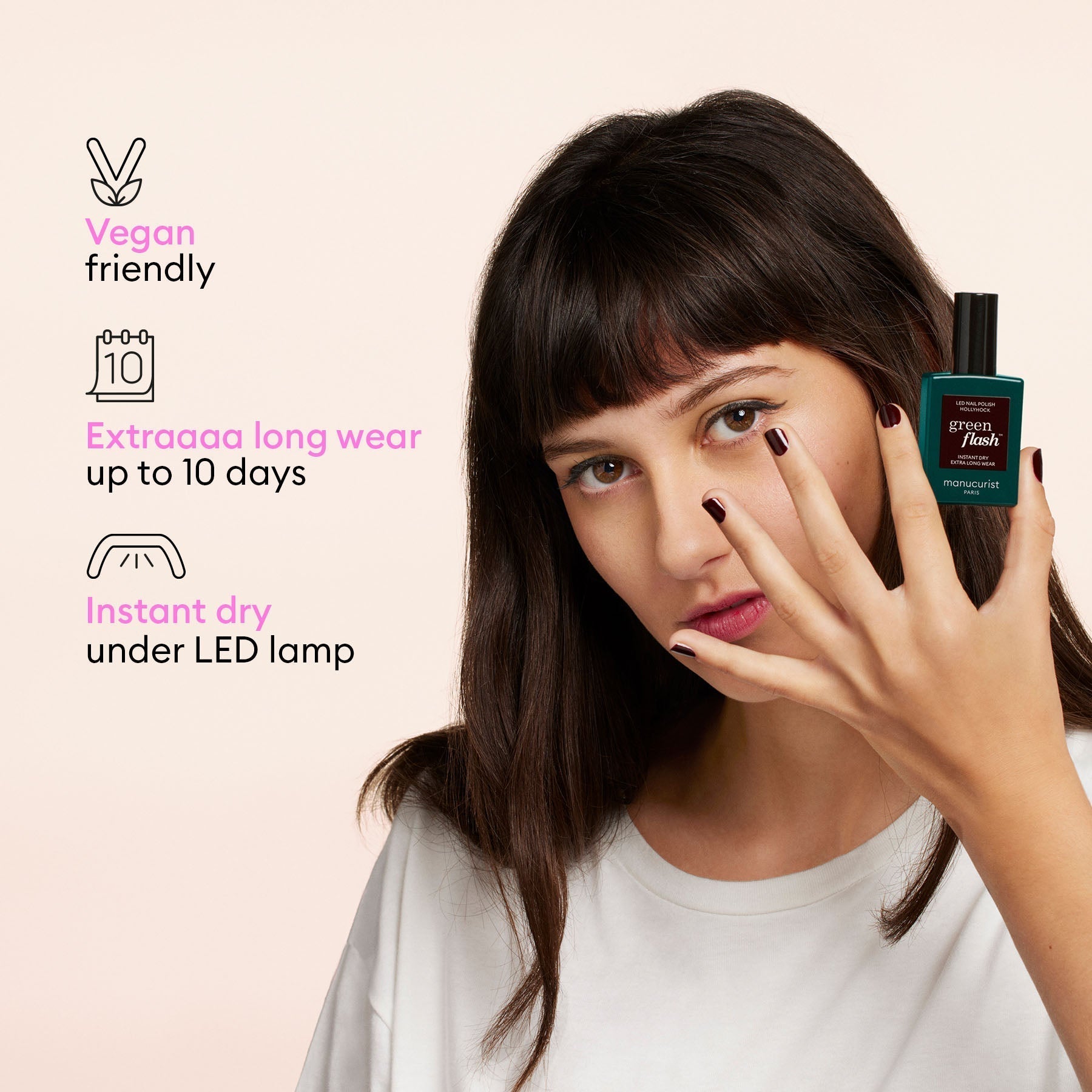 A woman with dark hair displays her gel polish and holds a Manucurist-test Green Flash™ Welcome Kit. Text notes it’s vegan, cures quickly for up to 10 days’ wear, and dries instantly under an LED lamp.