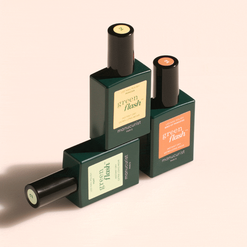 Three bottles from the Manucurist Customizable Trio in dark green rectangular bottles with colorful labels, artfully set on a light beige background—perfect for pairing with an acetone-free remover and creating your own rainbow.