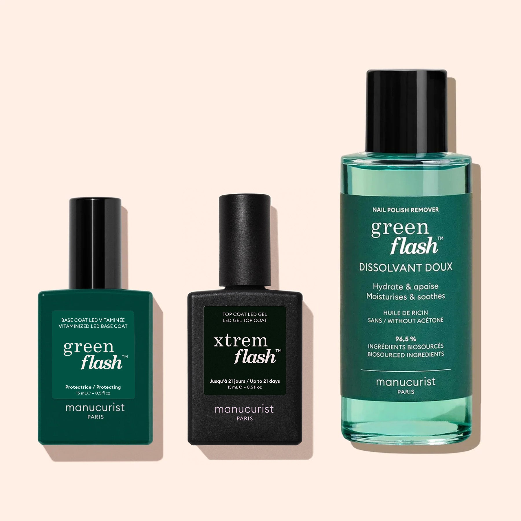 Three manicure products on a light background: a Green Flash LED base coat, a black LED top coat gel bottle, and a Manucurist Green Flash™ Gel Polish Remover bottle.