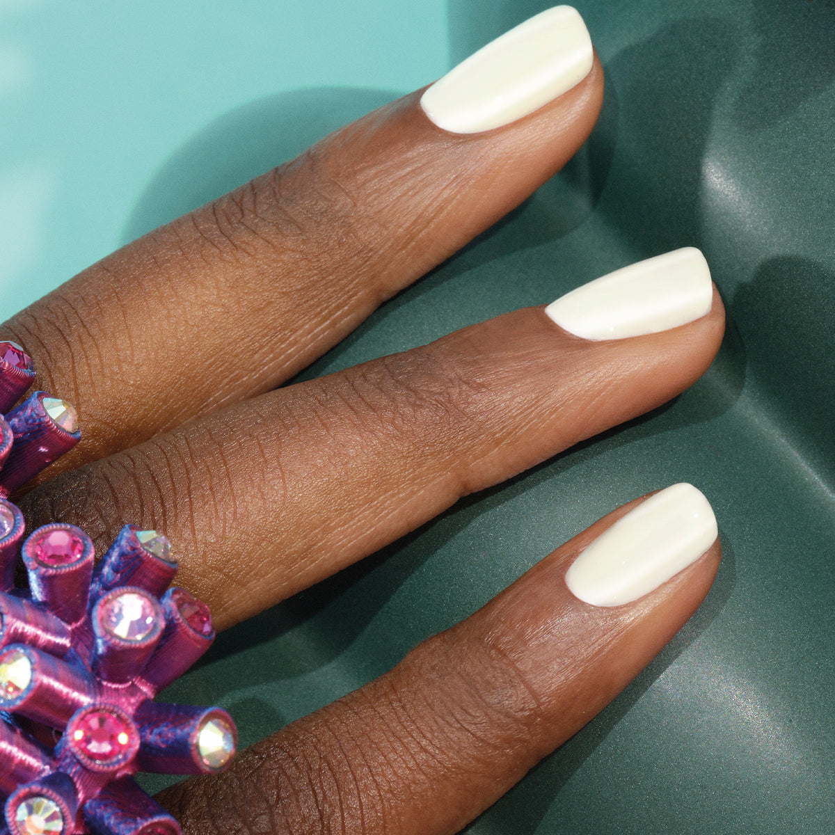 A hand with neatly manicured nails painted in Manucurist&