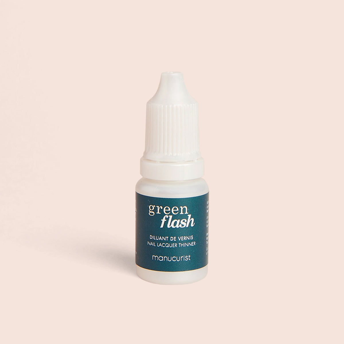 A small white bottle with a teal Green Flash™ Polish Thinner label by Manucurist-us stands upright on a light beige background—ideal for refreshing your gel nail polish or Base Coat.