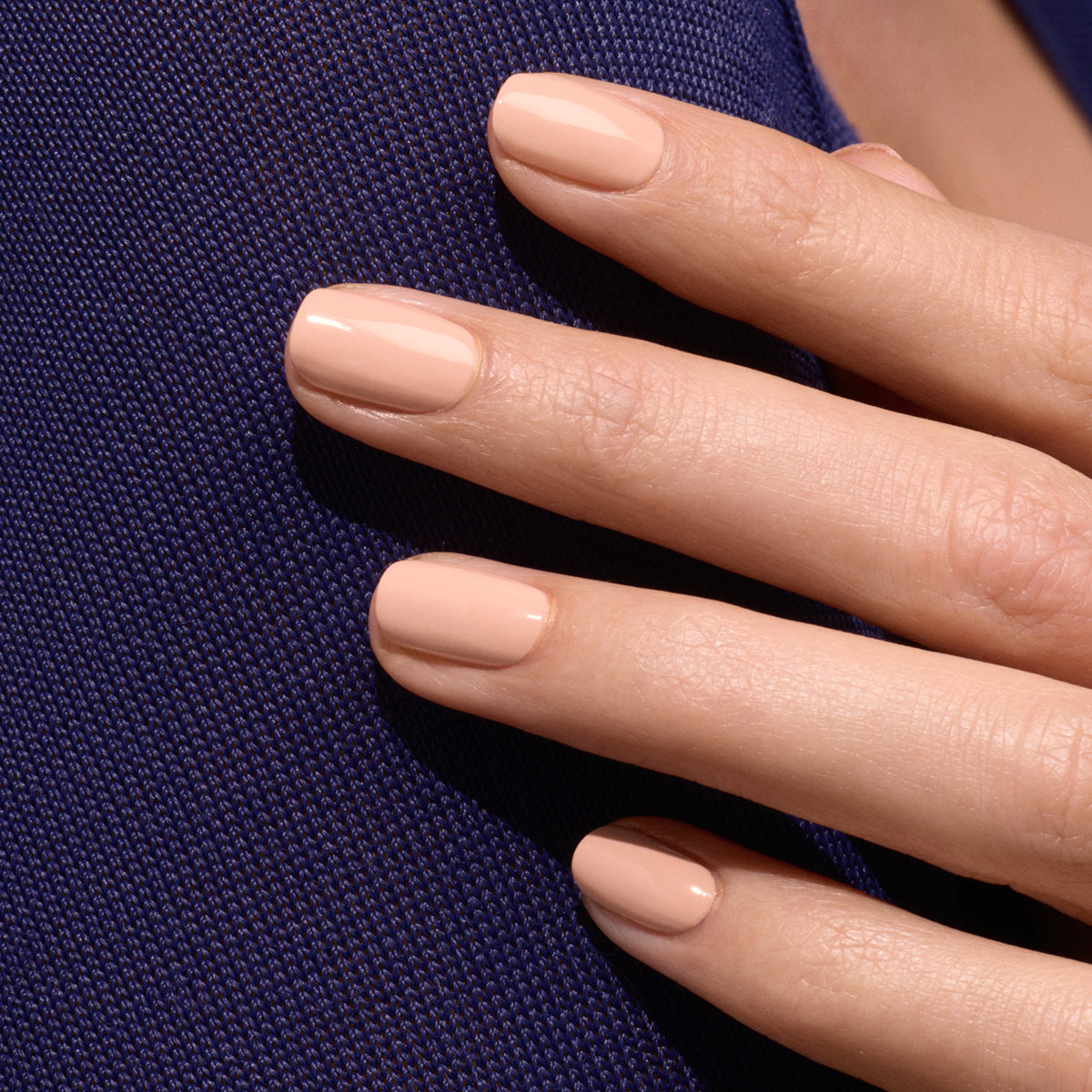 A close-up of a hand with neatly manicured nails painted in Manucurist&