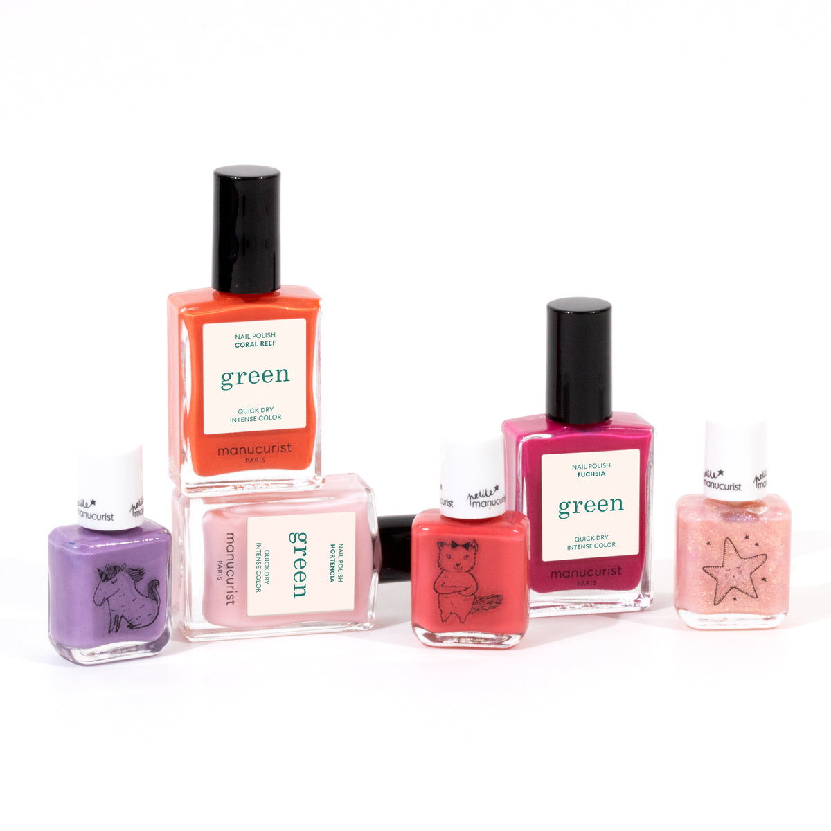 The Manucurist You Me at a Tea Party Green Set includes six water-based polishes in pink, red, and purple shades—plus a glittery pink—some with playful animal or star illustrations on the bottles.
