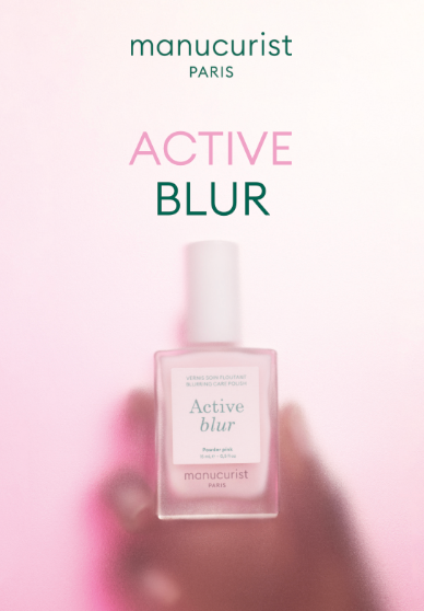 A translucent bottle of Leaflet Active™ Blur nail polish by Manucurist-test, with a white cap, is centered against a pink, softly blurred background. Above it are the words “Manucurist-test” and “Leaflet Active™ Blur.”.