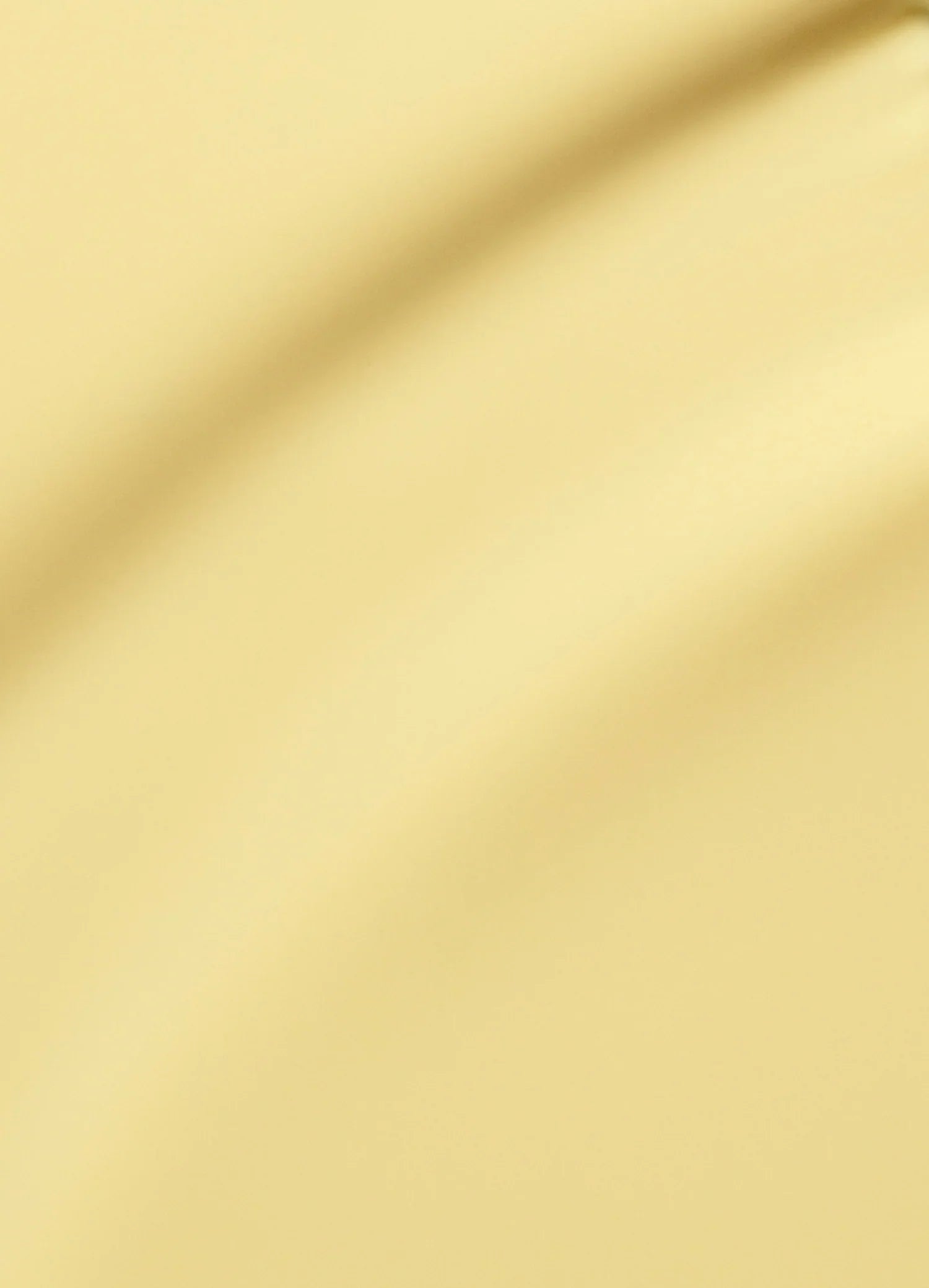 A soft, abstract background in light yellow with gentle, flowing diagonal curves and subtle shading, creating a smooth and calming visual effect.