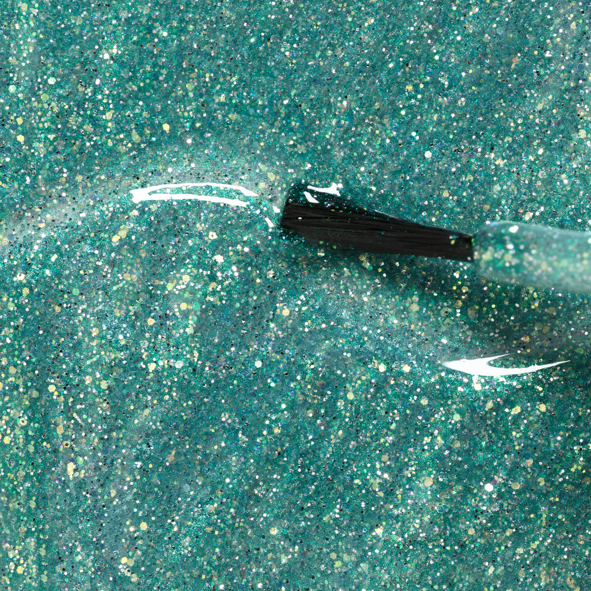 A close-up of a nail polish brush applying Manucurist’s Marius the Diplodocus, a teal glitter kids nail polish made with natural ingredients, highlighting sparkling particles on the shiny, textured surface.