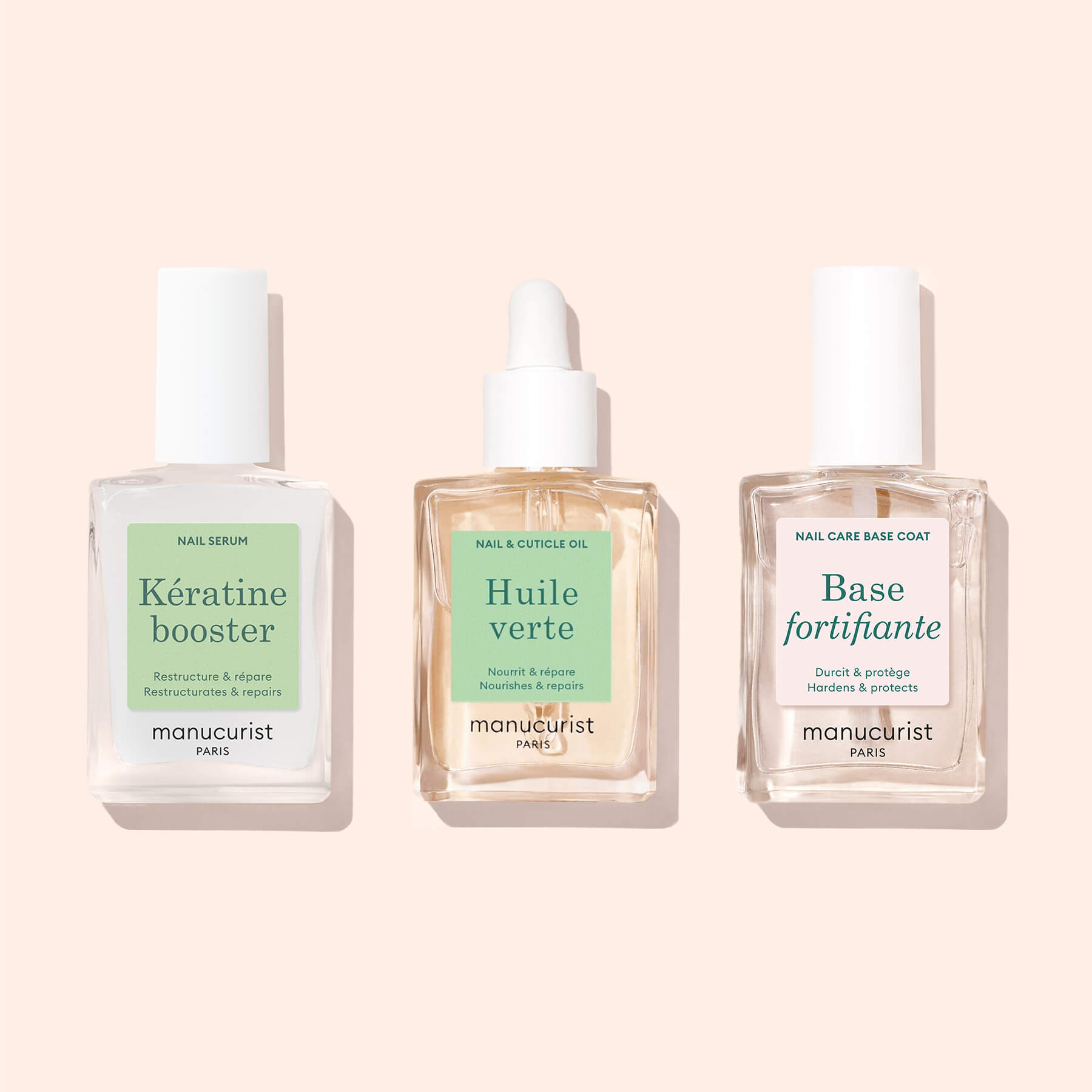 Three clear Manucurist Starter Routine - Soft Nails bottles with pastel labels—a keratin booster, Huile verte (with dropper), and Base fortifiante—are arranged side by side against a pale pink background.