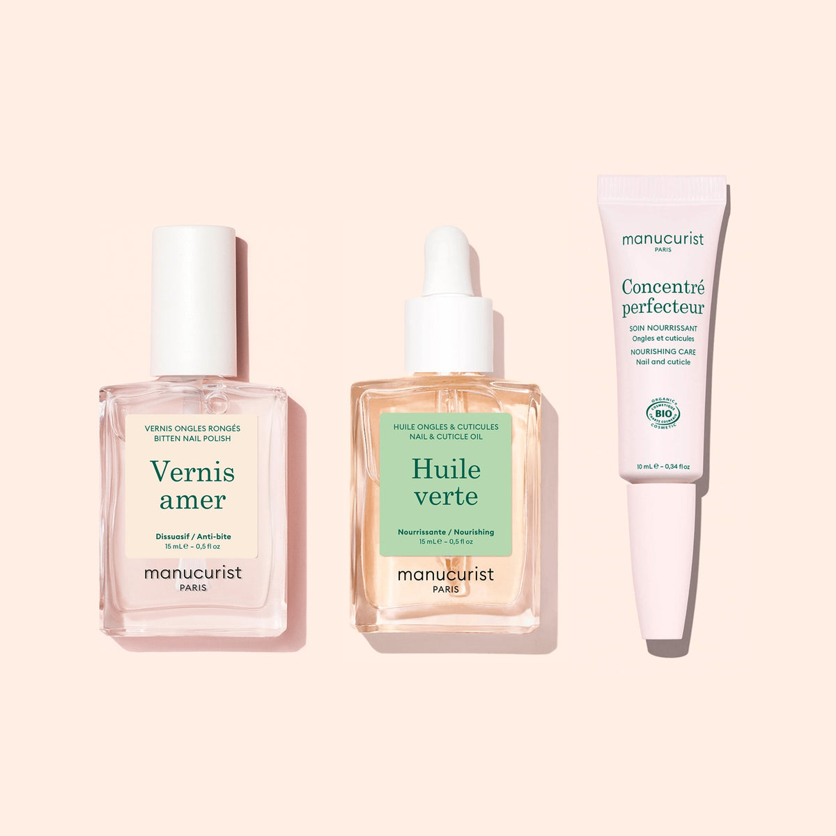 The Manucurist Starter Routine - Bitten Nails set—featuring a pink nail polish, a dropper bottle of nail and cuticle oil, and a nail treatment cream in a white tube on a pale pink background—is designed to support nail regrowth and restore beauty to bitten nails.
