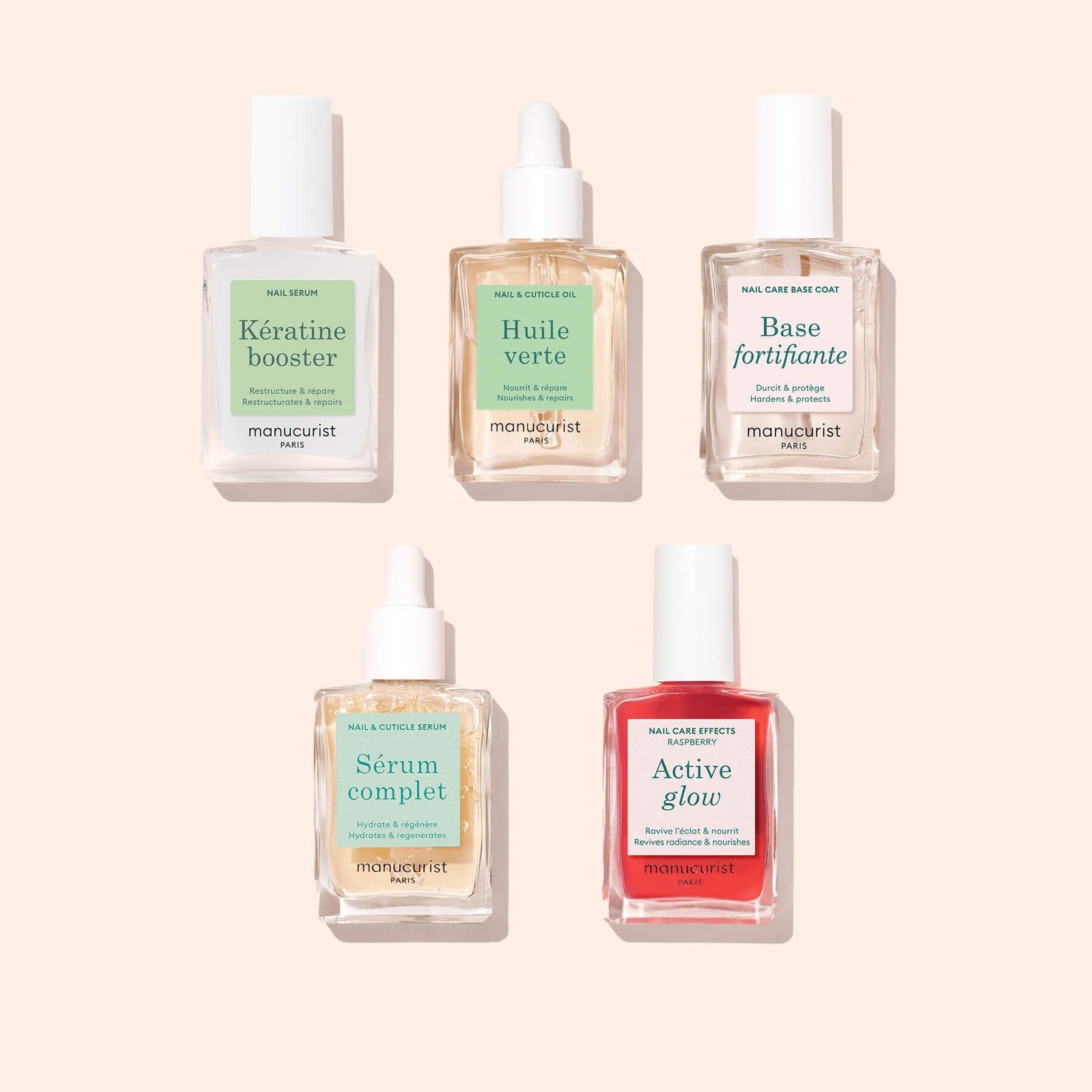 Five nail care bottles from Manucurist’s Basic Routine - Soft Nails on a pale pink background, featuring Keratin Booster, nourishing cuticle oil, and bases: Huile verte, Base fortifiante, Sérum complet, and Active glow.