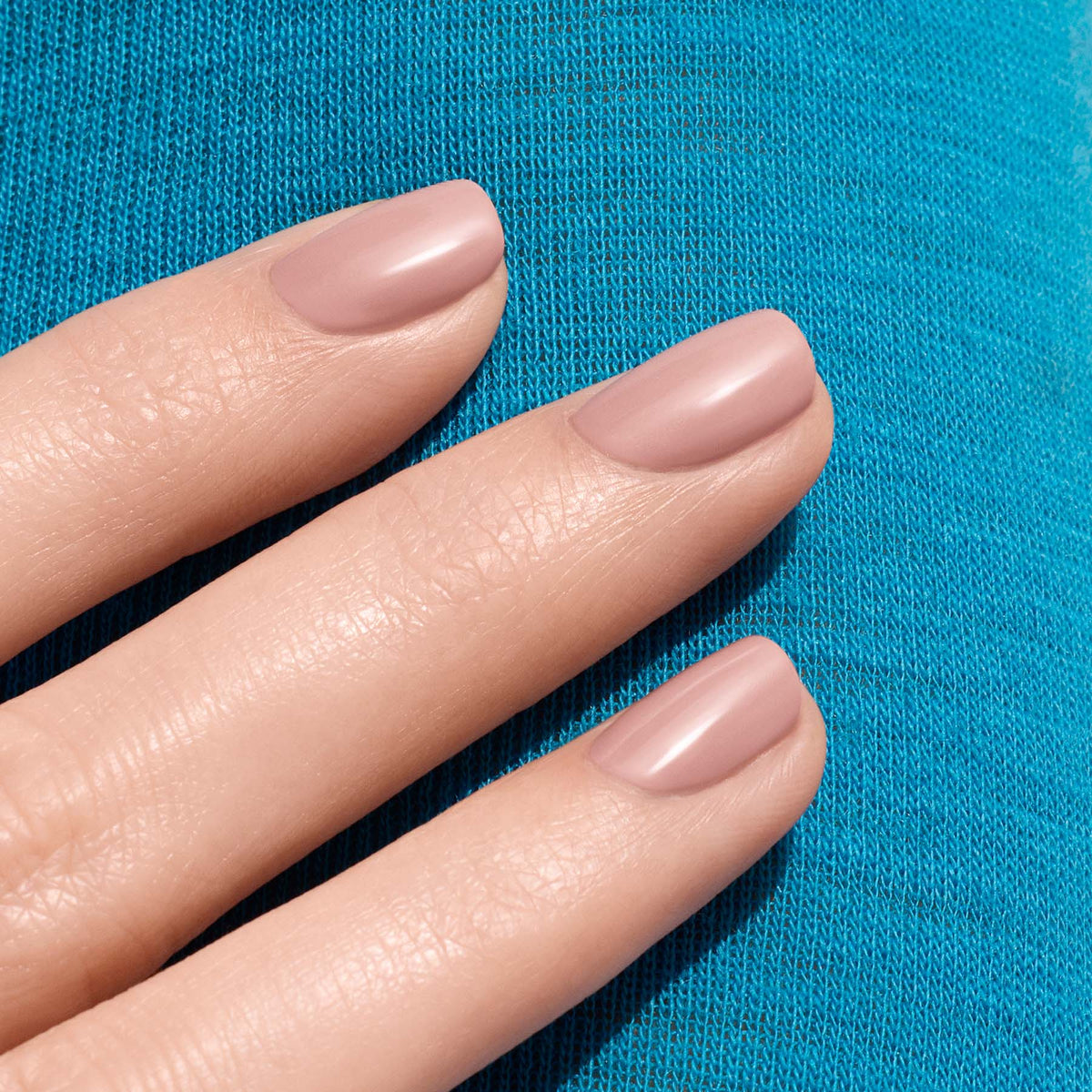 Three neatly manicured fingers showcase Manucurist&