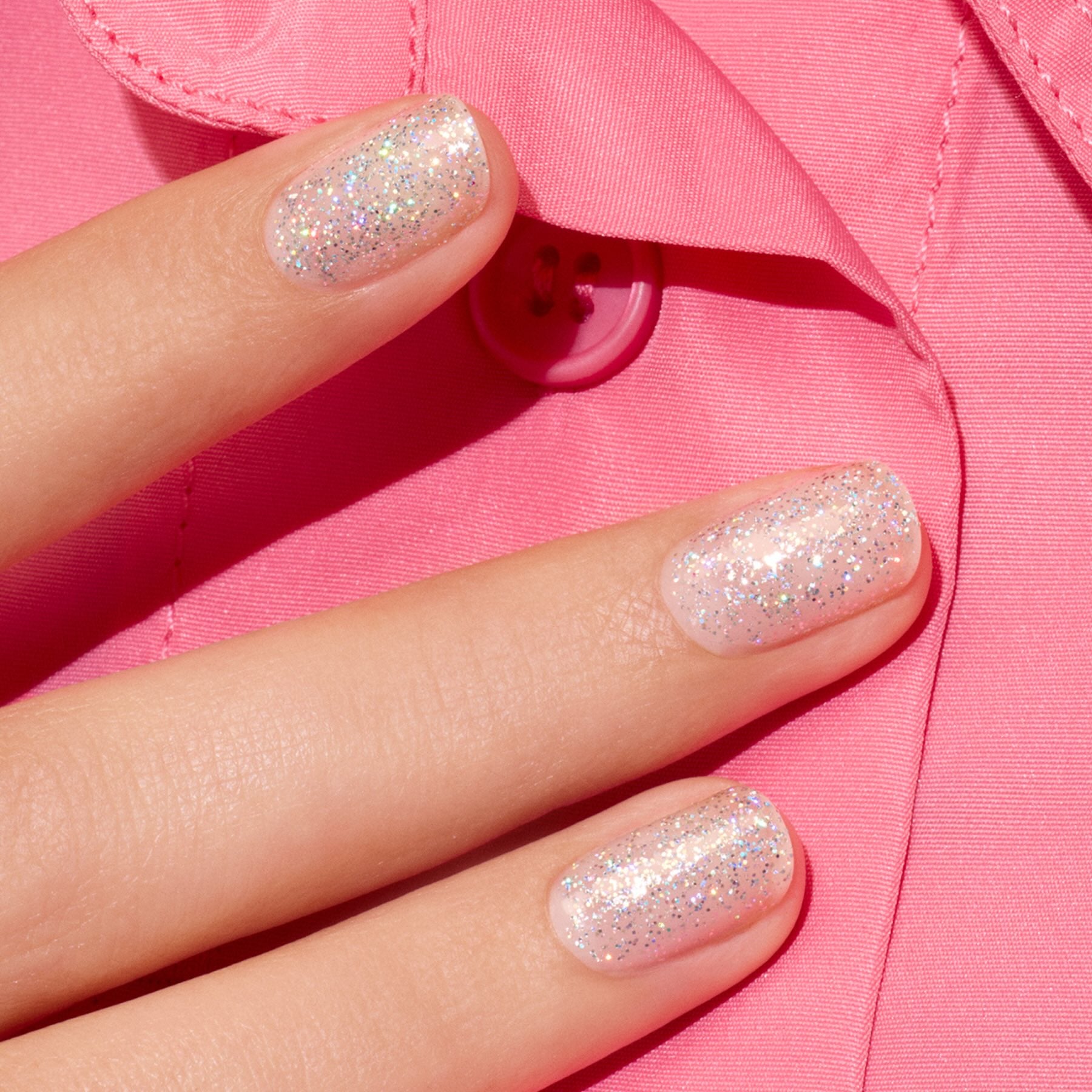 Three fingers with short nails painted in Manucurist&