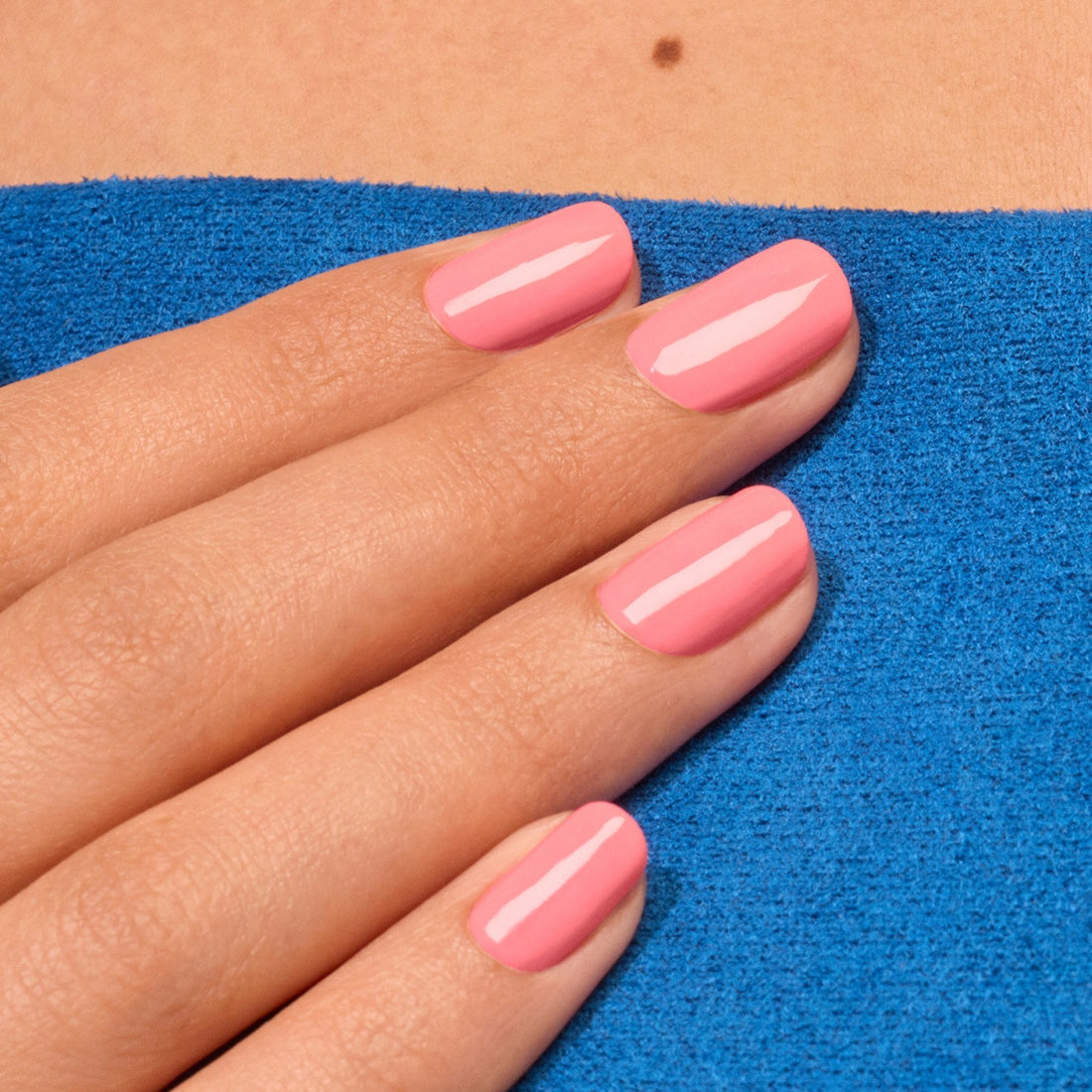 A hand with neatly manicured nails painted in Manucurist&
