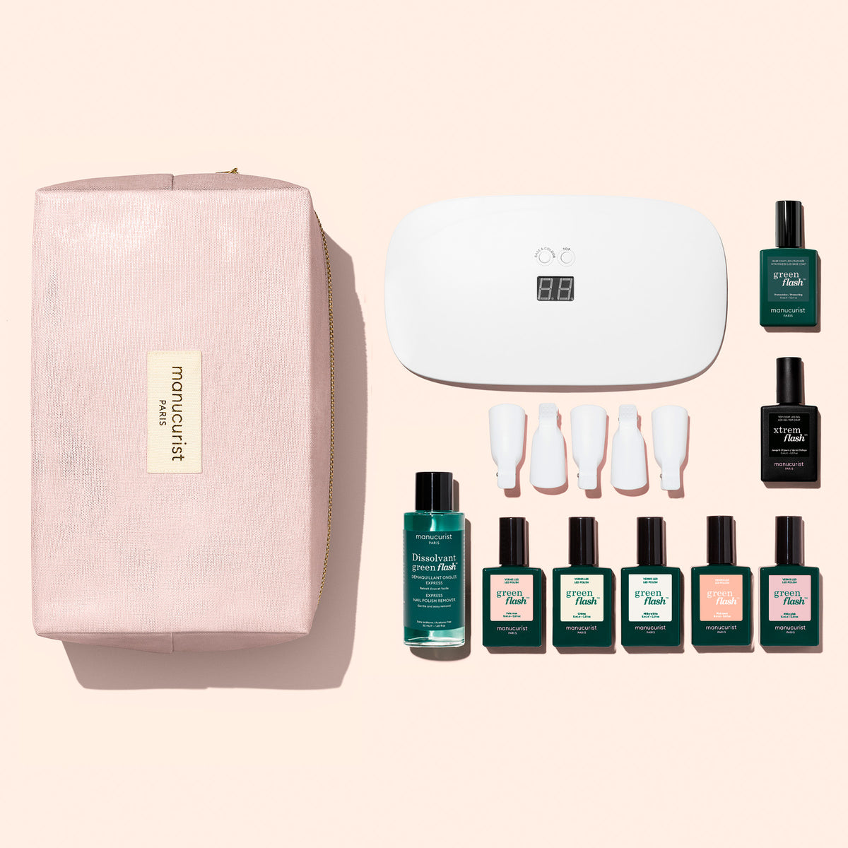 A Manucurist Super Starter Kit - Soap Nails LED Gel Polish in a pink cosmetics bag, featuring an LED lamp, nail polish remover, five gel polishes, a base coat, a top coat, and five plastic finger clips for an ultra-glossy manicure.