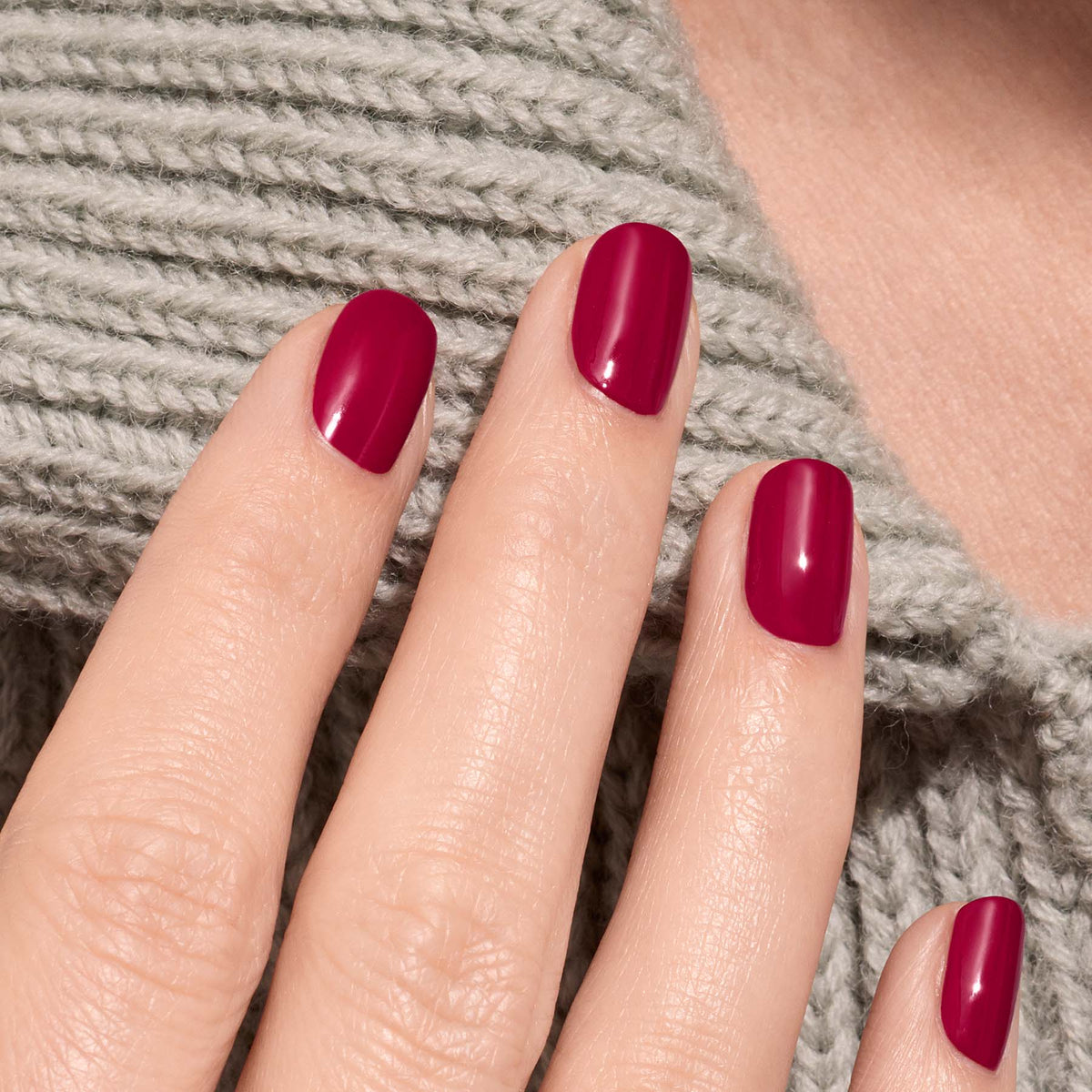 A hand with neatly manicured nails painted in Manucurist&