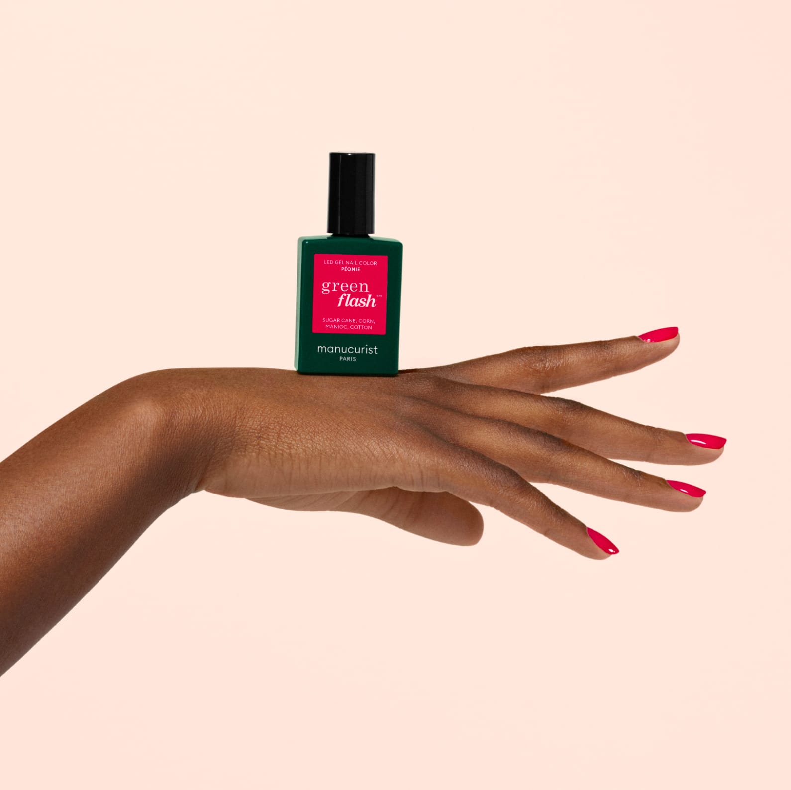 Manicured hand with Green Flash Bottle