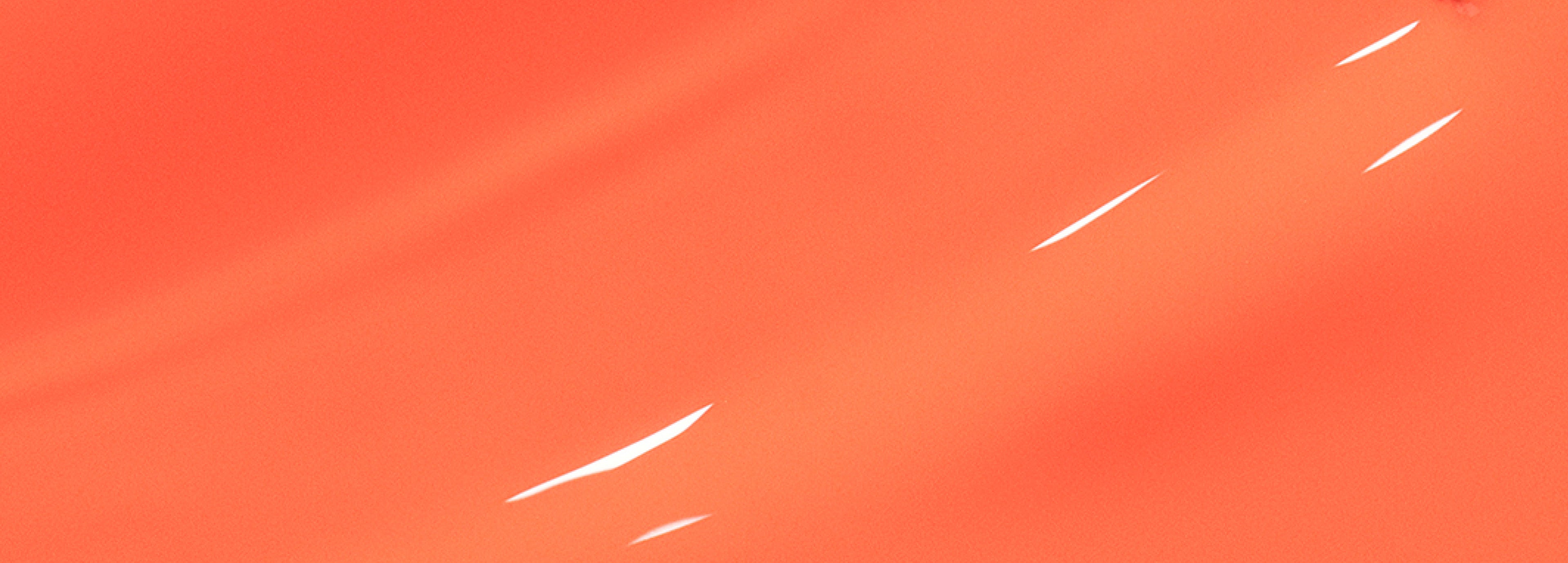 A smooth, abstract background in a solid coral orange color with several small, white reflective streaks.