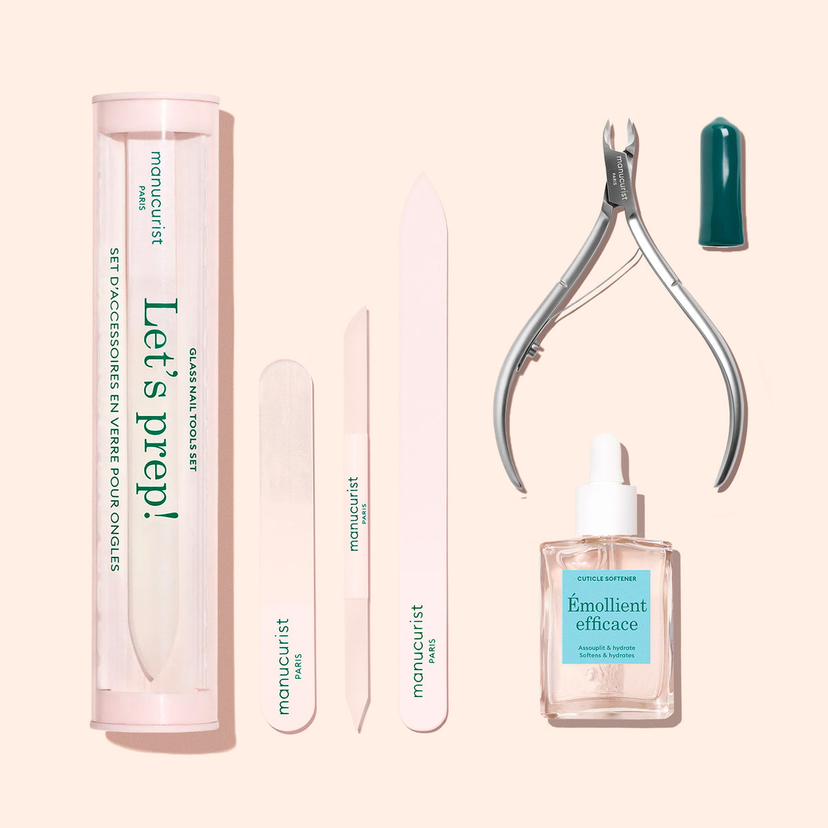 The Manucurist Nail Prep Set includes a pro emery board in a tube, buffer, white and glass nail file, metal cuticle nippers, and cuticle softener—displayed on a light peach background.