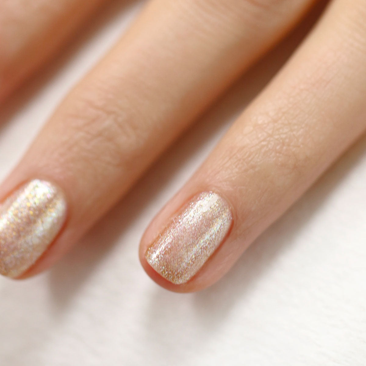 Close-up of two fingers with short, neat nails painted in Manucurist&