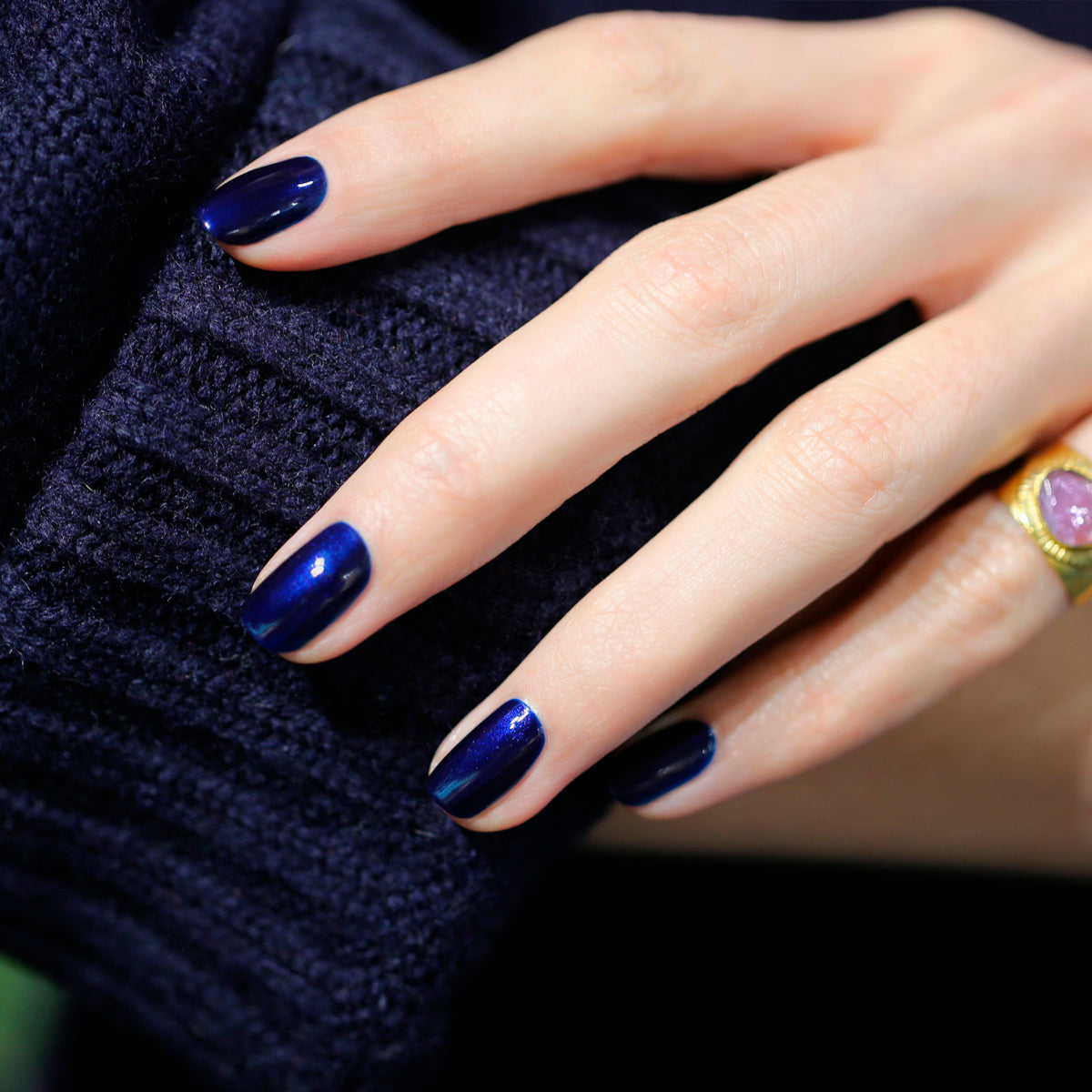 A hand with neatly manicured nails painted in Manucurist&