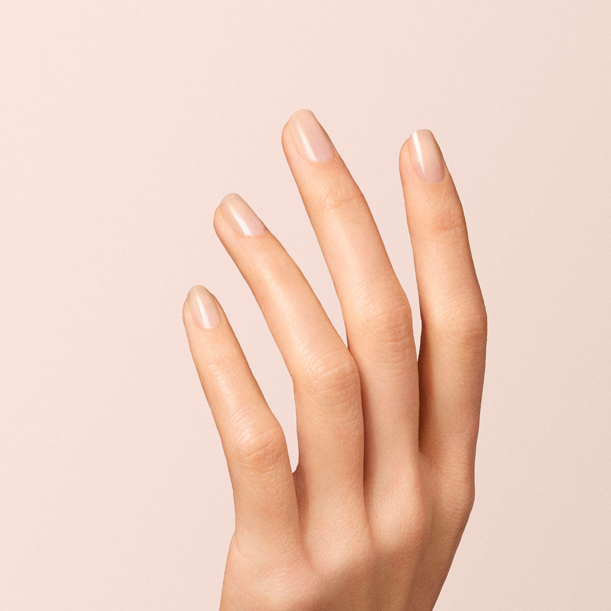 A close-up of a hand with neatly manicured nails, painted in Manucurist&