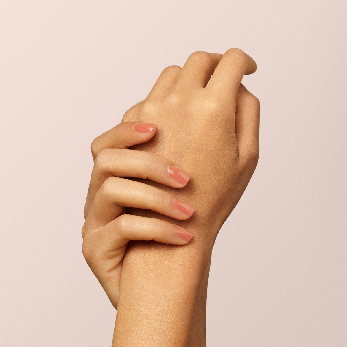 A close-up of two hands with neatly manicured nails painted in Manucurist&