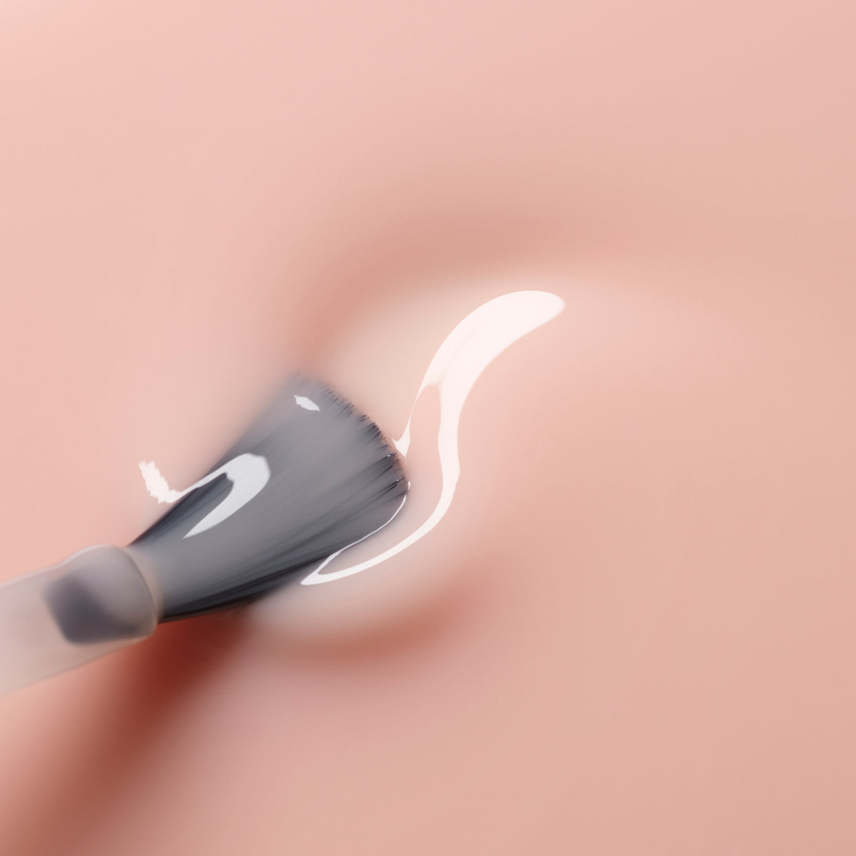 A close-up of a brush spreading Manucurist&