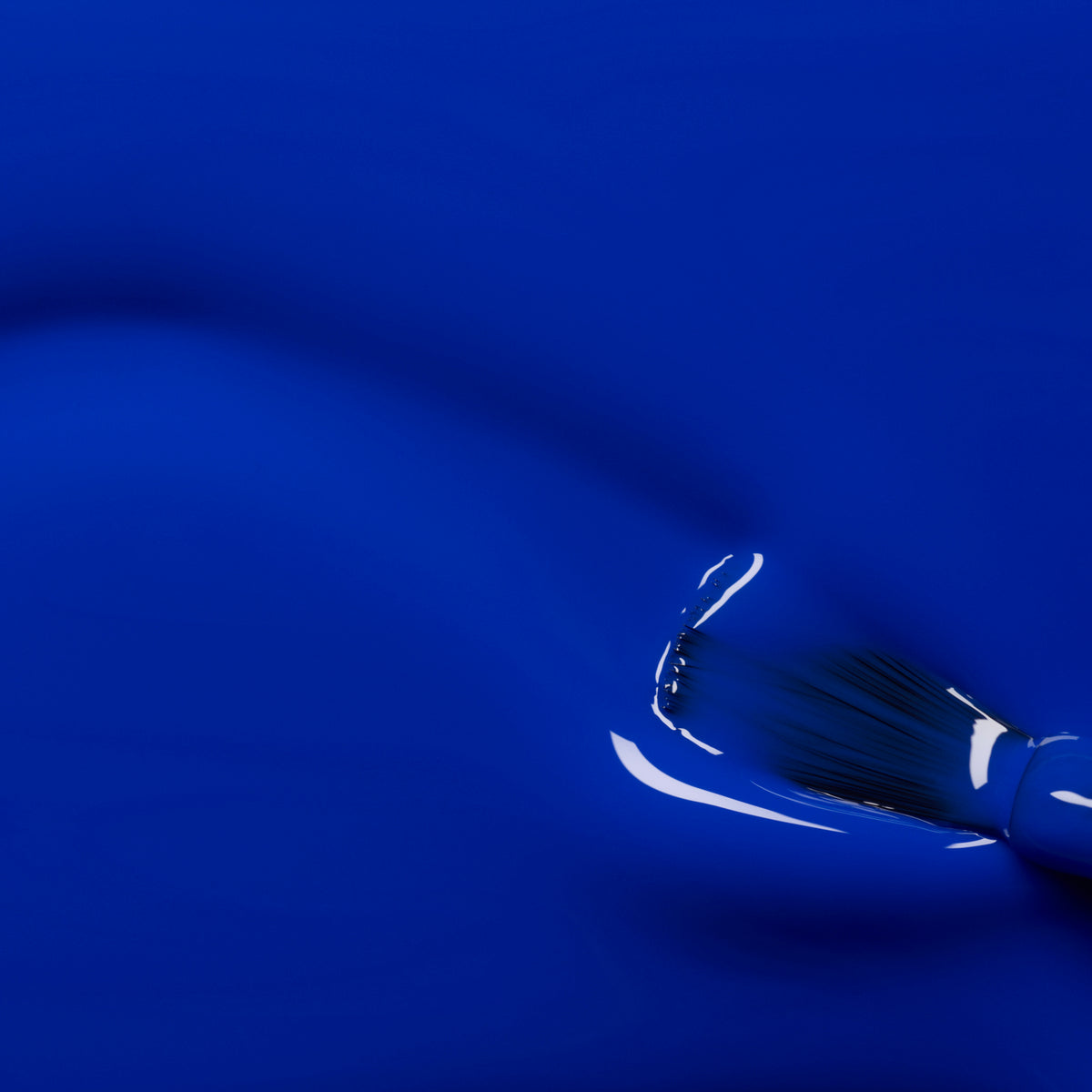 A close-up of a paintbrush applying Manucurist&
