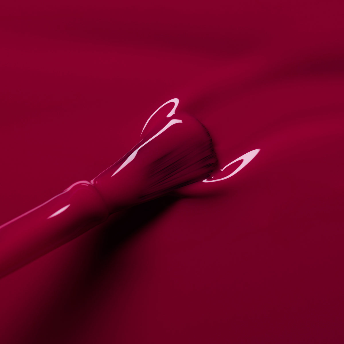 A close-up of a nail polish brush spreading Manucurist&