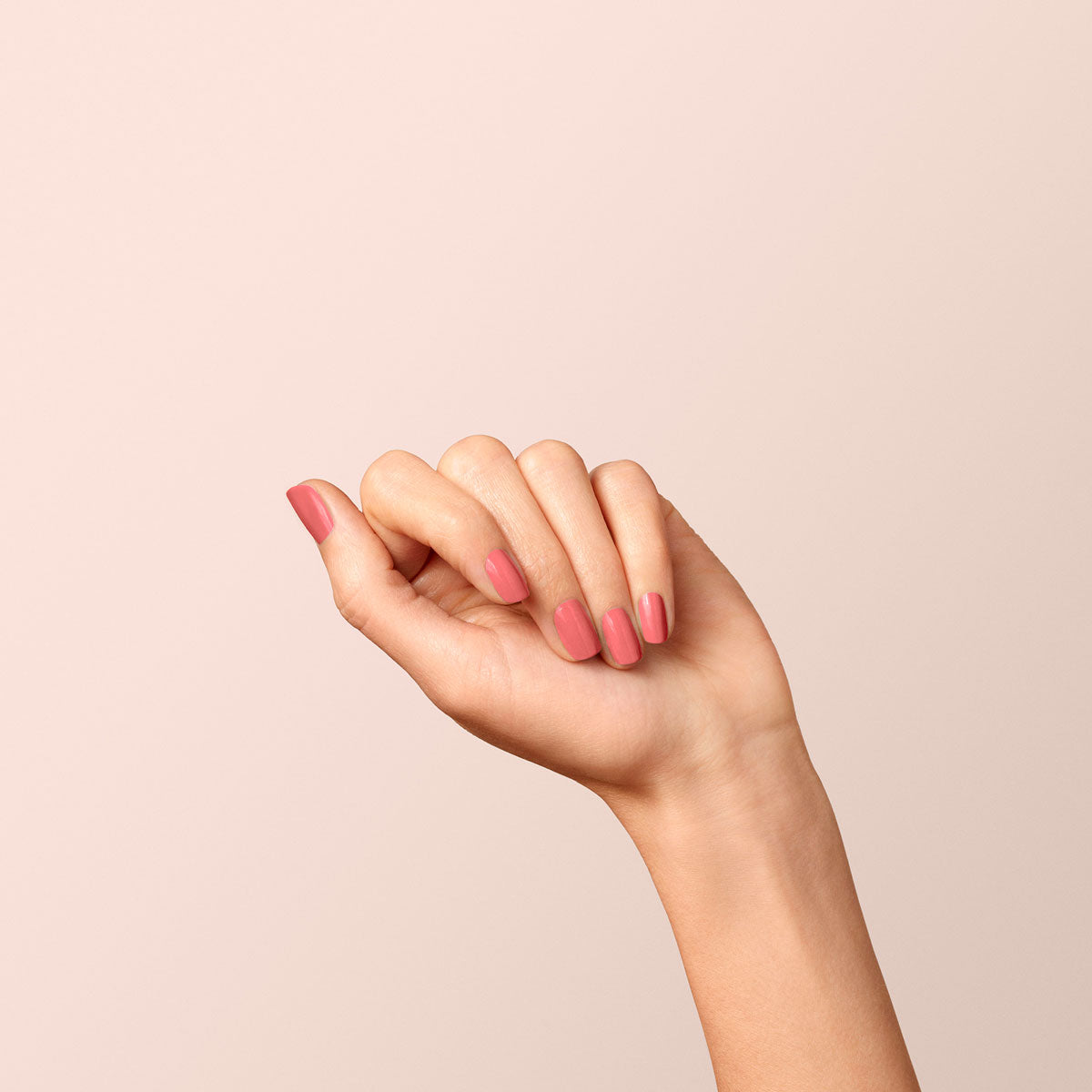 A hand with neatly manicured nails painted in Manucurist&
