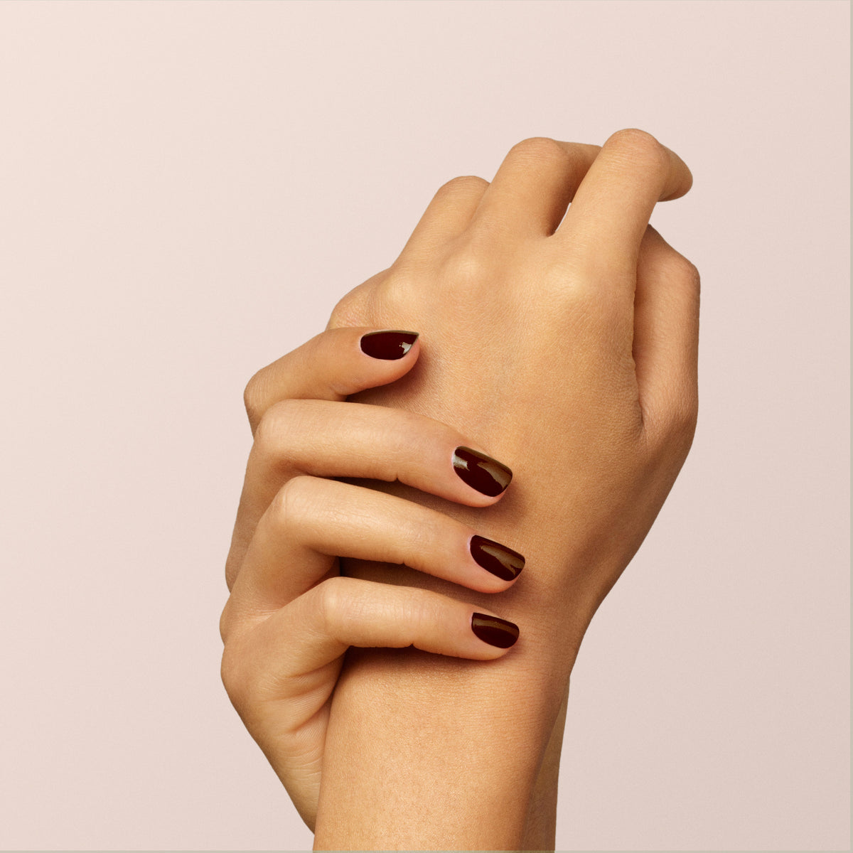 A close-up of two hands with neatly manicured nails painted in Manucurist&