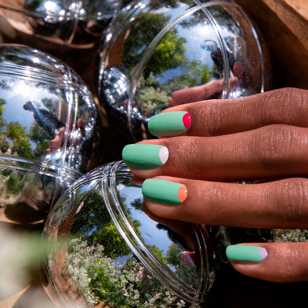 A hand with modern nail art showcases Manucurist&