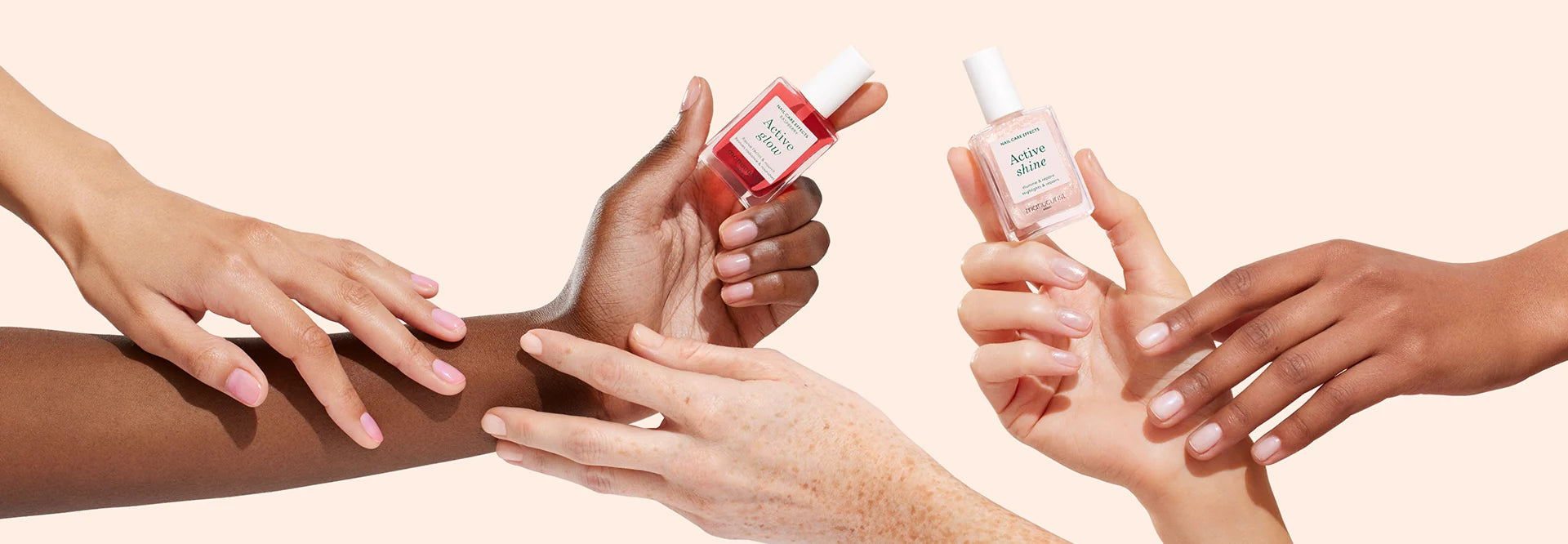 Three pairs of diverse hands display manicured nails while holding and applying bottles of nail polish against a light peach background.