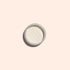 Une petite boîte métallique de Golden Glazed Effect Powder de Manucurist — une fine poudre blanc cassé qui donne aux ongles un scintillement doré nacré — est centrée sur un fond beige clair et projette une douce ombre vers la gauche.