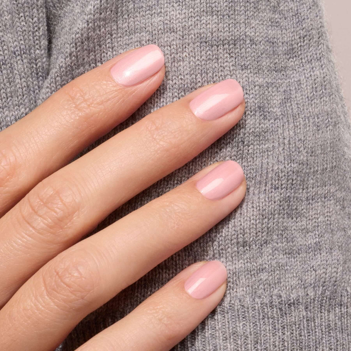 A hand with neatly manicured nails painted in Manucurist&
