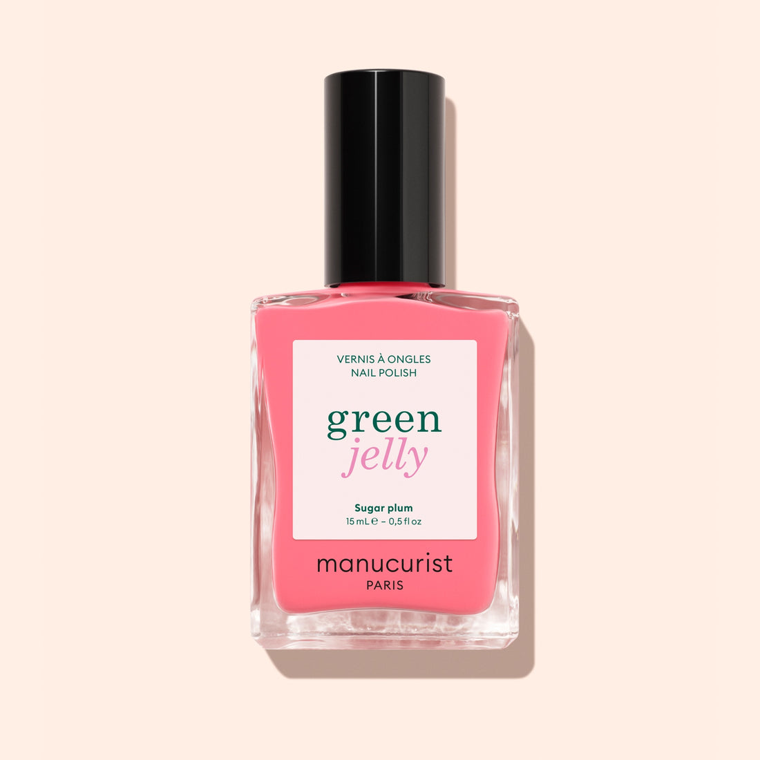 A bottle of Manucurist Sugar Plum jelly nail polish, translucent pink shade with a black cap. The label says “green jelly” and “vernis à ongles nail polish” on a light pink background.