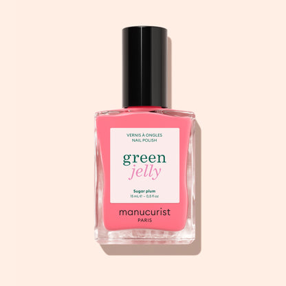 A bottle of Manucurist Sugar Plum jelly nail polish, translucent pink shade with a black cap. The label says “green jelly” and “vernis à ongles nail polish” on a light pink background.