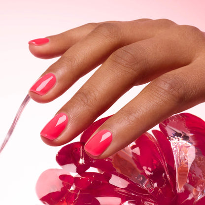 A hand with short, glossy nails painted in Manucurist&