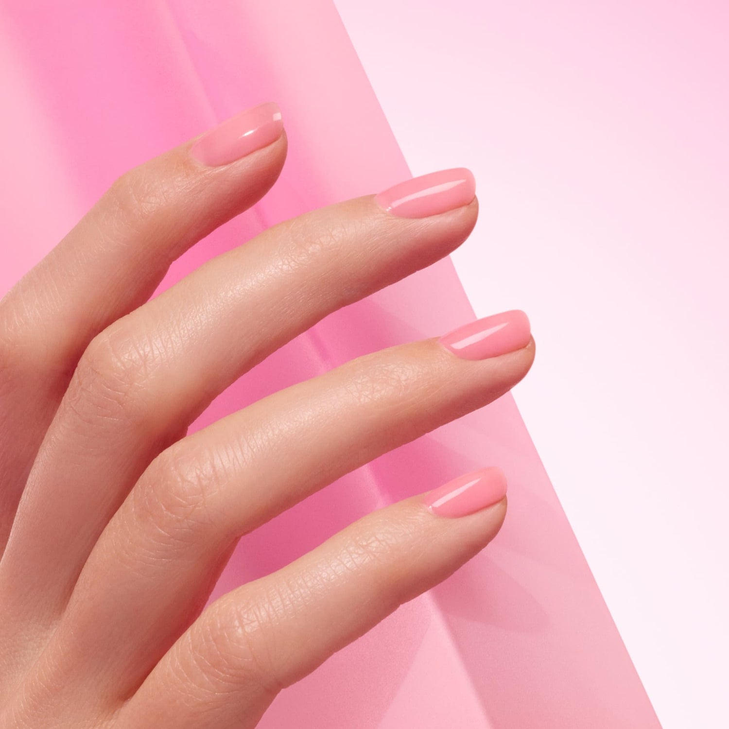 A hand with neatly manicured nails painted in Manucurist&