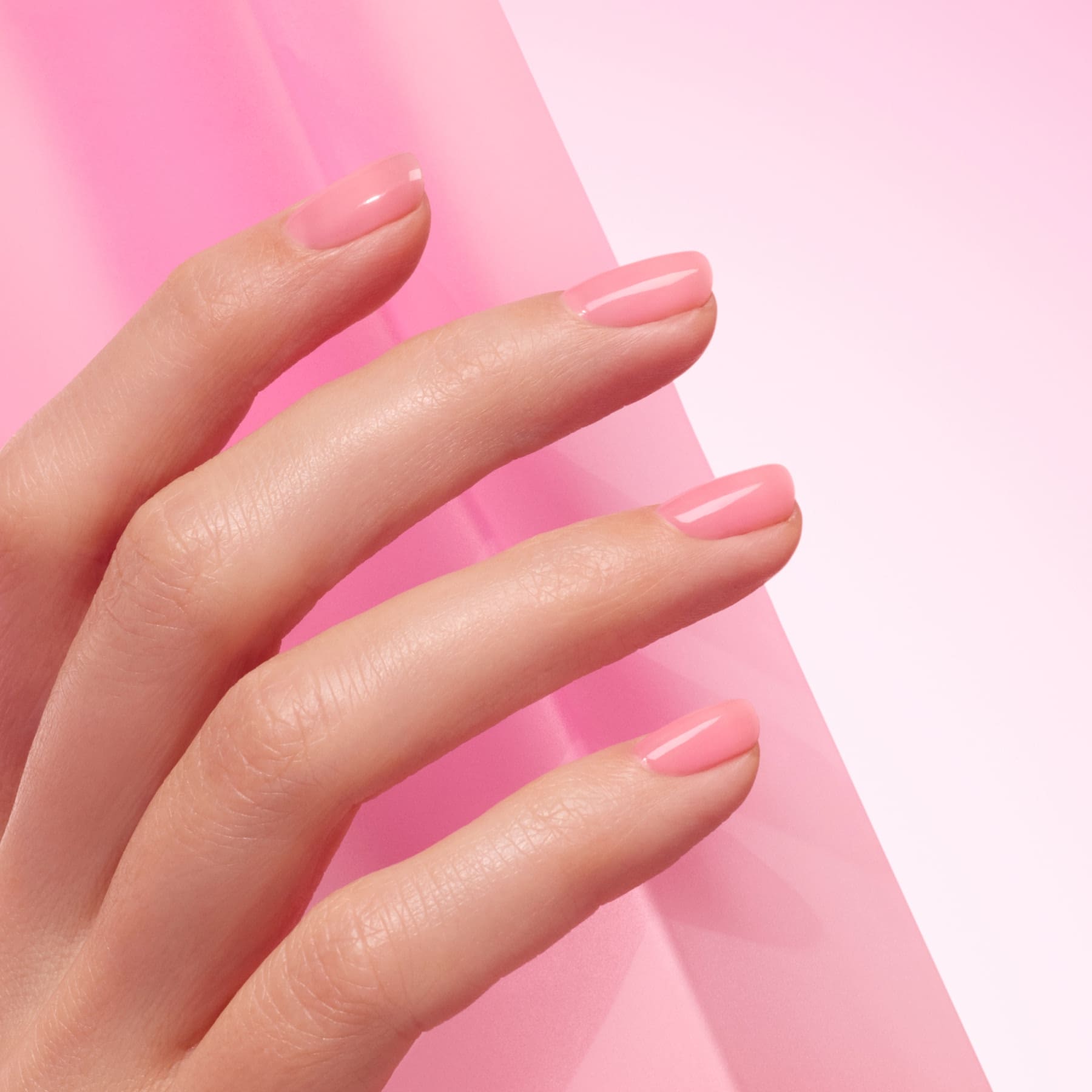 A hand with neatly manicured nails painted in Manucurist&