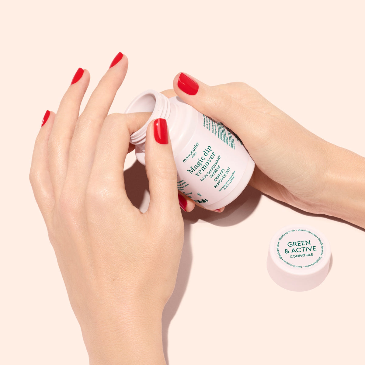 A person with red nail polish opens a white supplement bottle labeled Magnesium with Green  Active on the lid, on a light peach background.