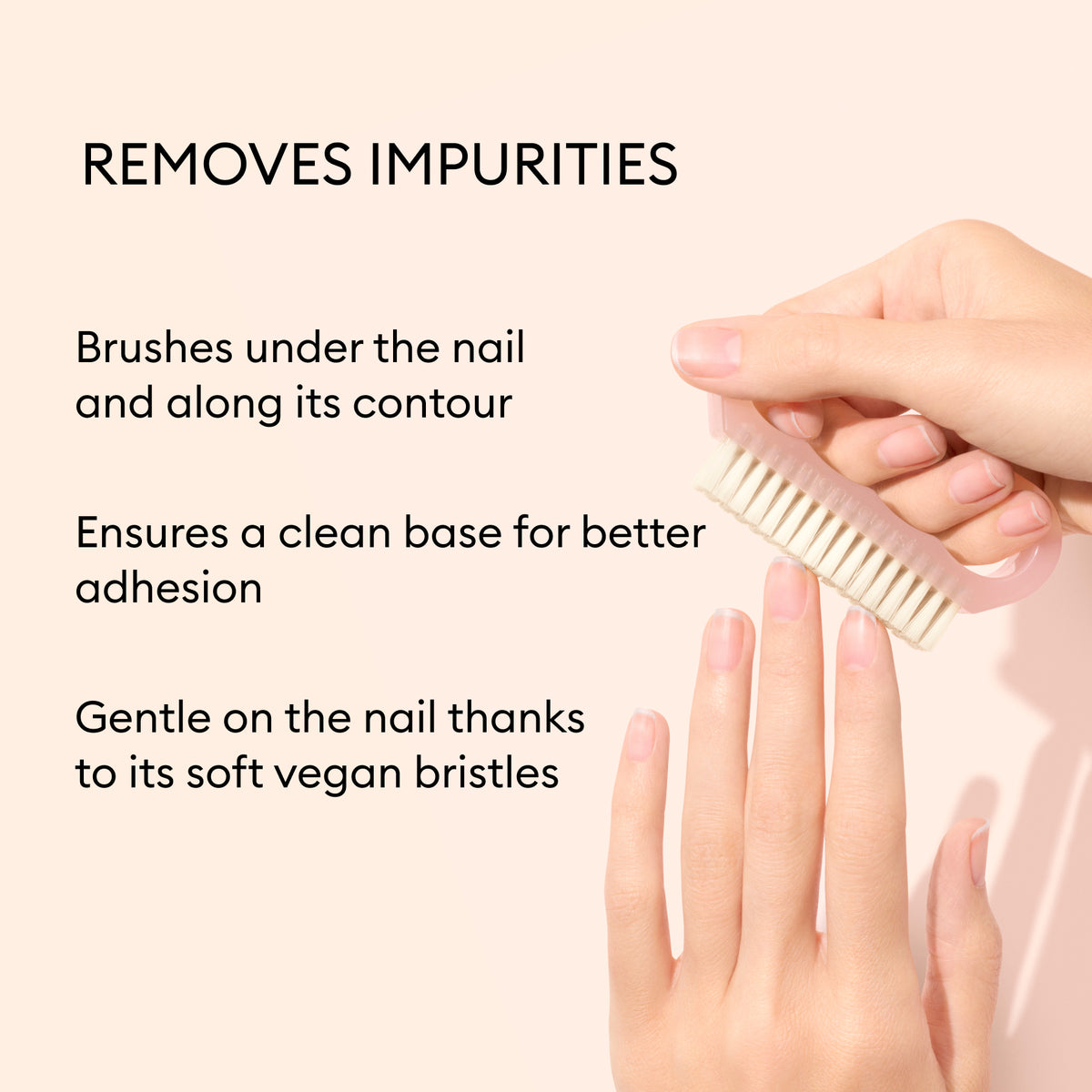 A hand uses the Manucurist-us Nail Brush to gently clean under and around fingernails. Its soft vegan bristles effectively remove impurities, ensuring a thorough clean for better manicure adhesion.