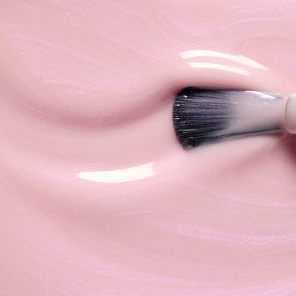 A close-up of a makeup brush swirling through Manucurist&
