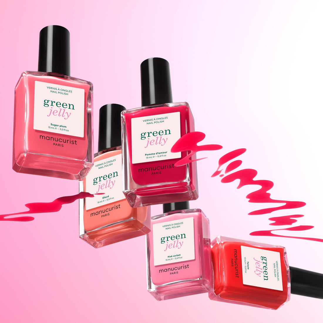 Five bottles from Manucurist’s Curated Color Collections are arranged on a pink gradient background, featuring swirling polish strokes that showcase the brand’s trend-forward shades perfect for stylish manicures.