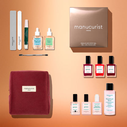 Flat lay of the Manucurist Green™ Starter Kit Gift Set, showcasing manicure essentials like naturally derived nail polish, two small bottles, manicure tools, a nail file, a burgundy pouch, and a gold box—all artfully arranged in neat rows and columns on a copper backdrop.