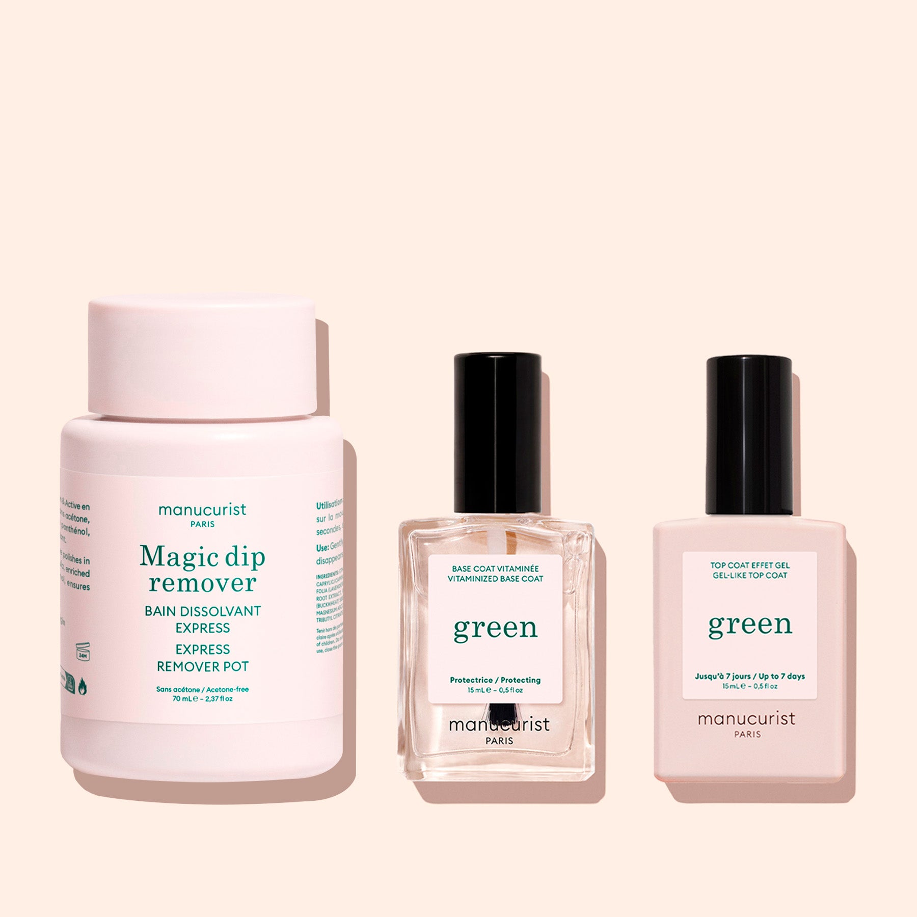 Three Manucurist products on a beige background: the travel-friendly, acetone-free Magic Dip Remover pot, Green base coat in a clear bottle, and Green top coat in a light pink bottle.