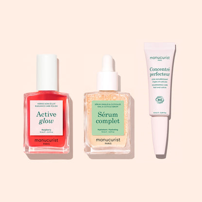 The Manucurist Basic Routine - Sensitive Nails set includes a bottle of pink nail polish, a bottle of clear nail and cuticle serum, and a tube of nail care cream to help strengthen nails.