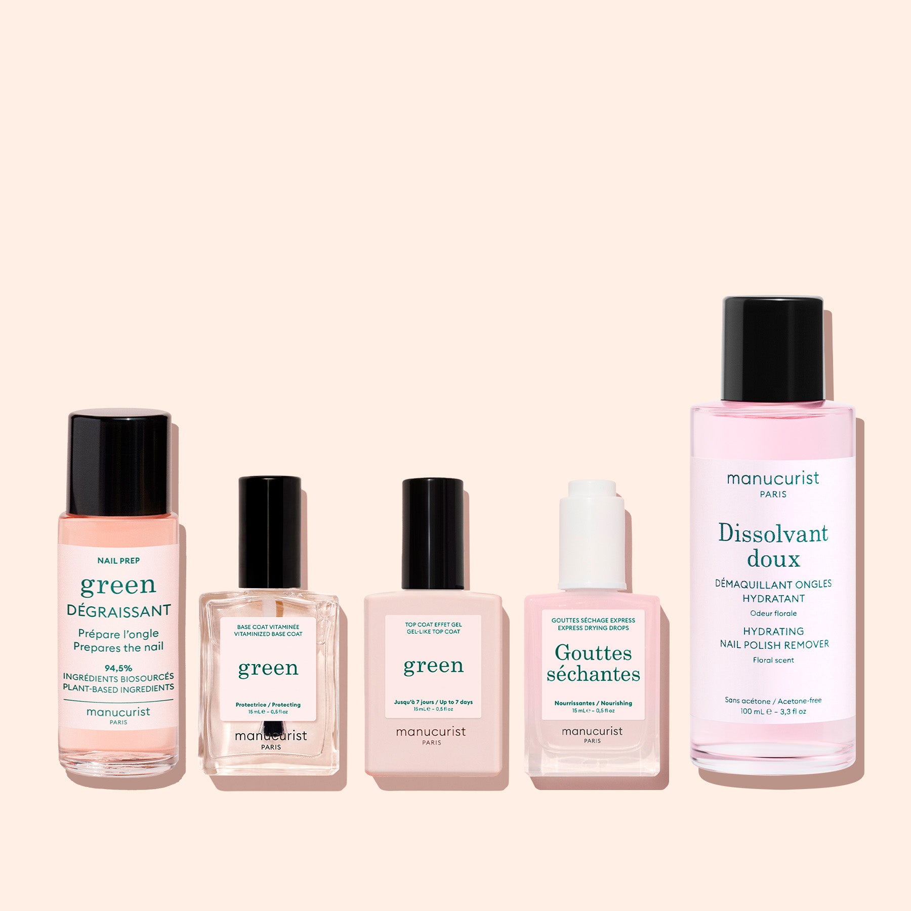 Five manicure products from Manucurist, including the Green™ Base, Top Coat  Nail Polish Remover Trio, are displayed in bottles and jars of varying sizes on a light background. The French and English labels showcase the brand and product names for nail and polish care with naturally derived formulas—perfect for achieving a flawless manicure.